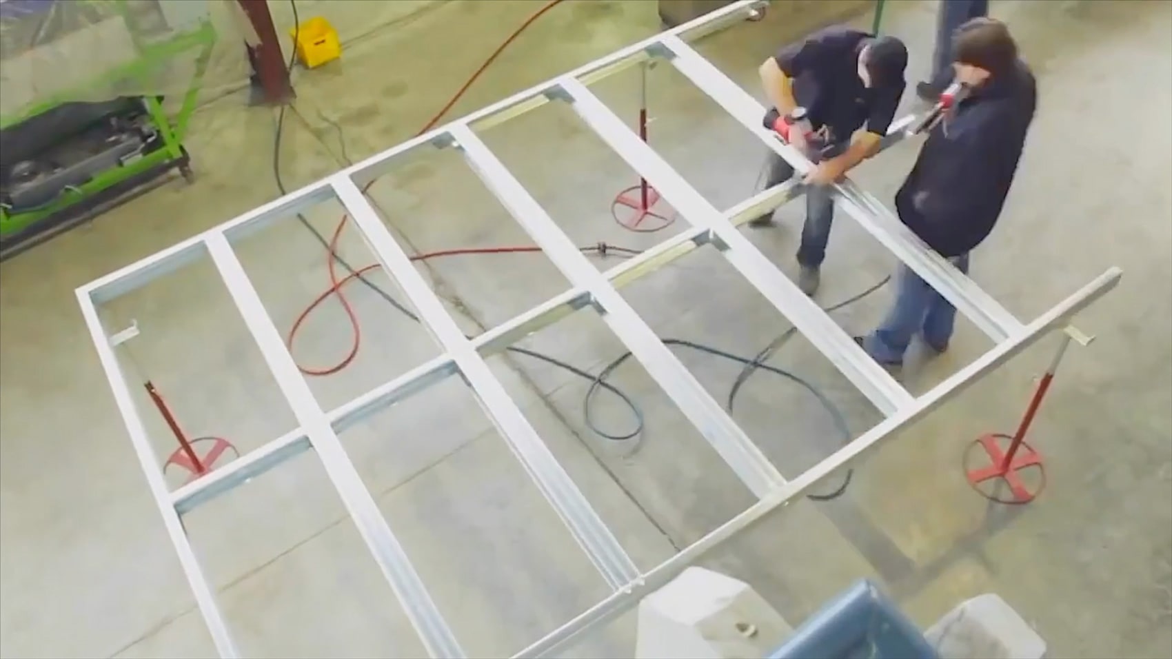 steel fabricators working on framed steel wall section